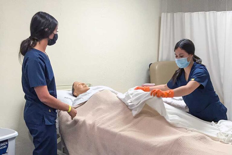 Students_learning_how_to_move_simulation_patient_in_bed_hero