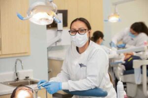 Image of student working on another student in the dental lab.