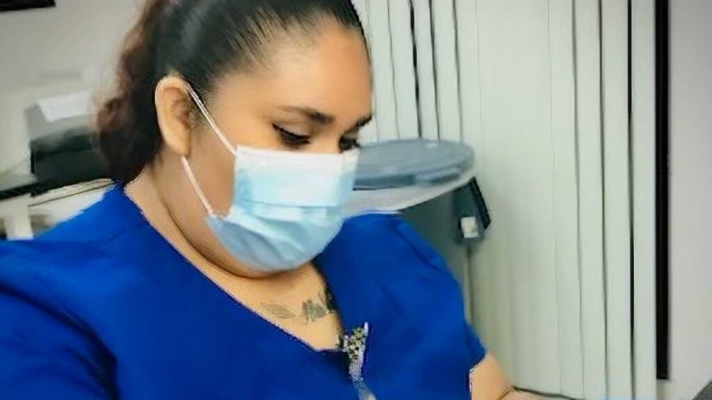 woman in scrubs works with test tubes in a phlebotomy lab environment