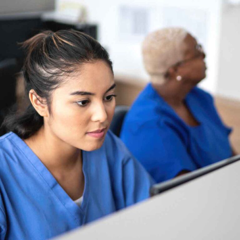 administration workers at a welcome desk in a clinical setting