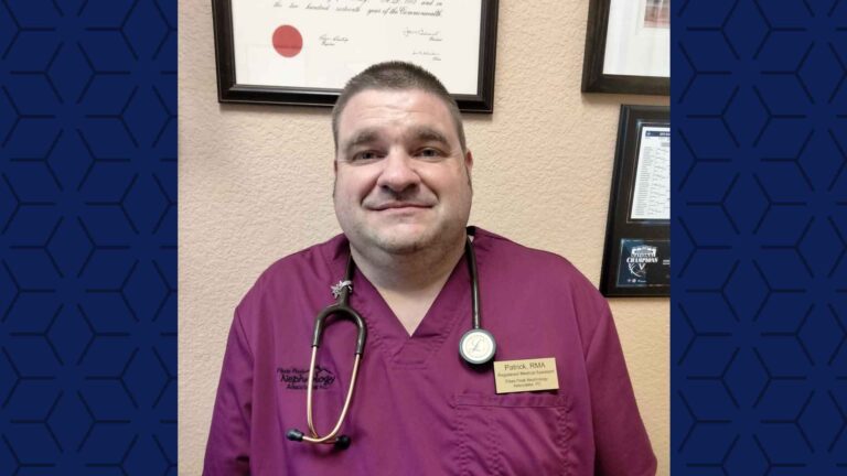 close up selfie of male nurse in red/maroon scrubs