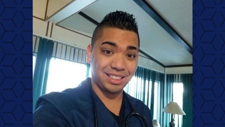 close up selfie of male nurse in blue scrubs