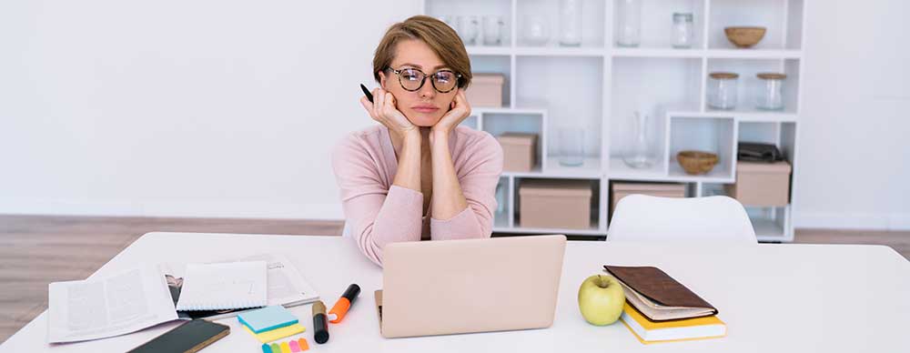 photo of online student at home watching lessons on a laptop